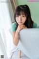 A woman sitting on top of a white couch.