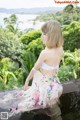 A woman in a white bikini top and a floral skirt.